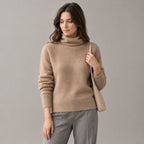 Rothbury Ribbed Knit Turtleneck — Camel turtleneck sweater worn by a model against a neutral studio backdrop.