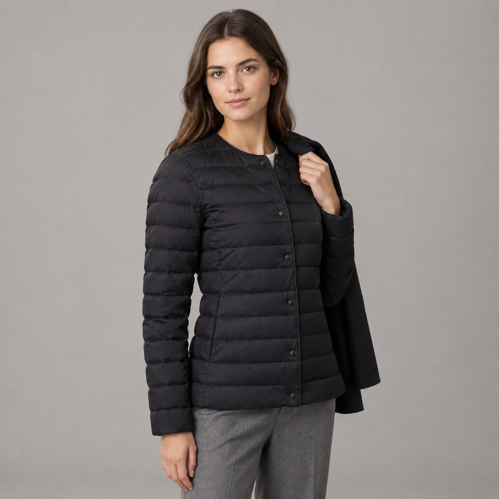 Hatherley Quilted Down Jacket — Black collarless quilted down jacket worn by a model in a neutral studio setting.