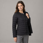 Hatherley Quilted Down Jacket — Black collarless quilted down jacket worn by a model in a neutral studio setting.
