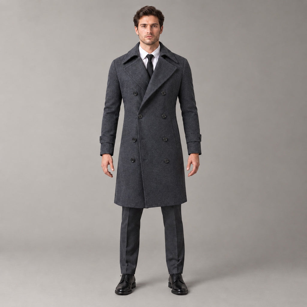 Norbury Cotton Blend Trench Coat — Dark gray double-breasted trench coat worn by a model against a pale stone studio backdrop.