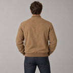 Kinloch Faux Suede Bomber Jacket — Back of the caramel faux-suede bomber jacket worn, showing the horizontal back yoke and ribbed hem.