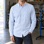 Longford Cotton Oxford Shirt — Light Blue cotton oxford shirt worn by a model in a navy panelled room.