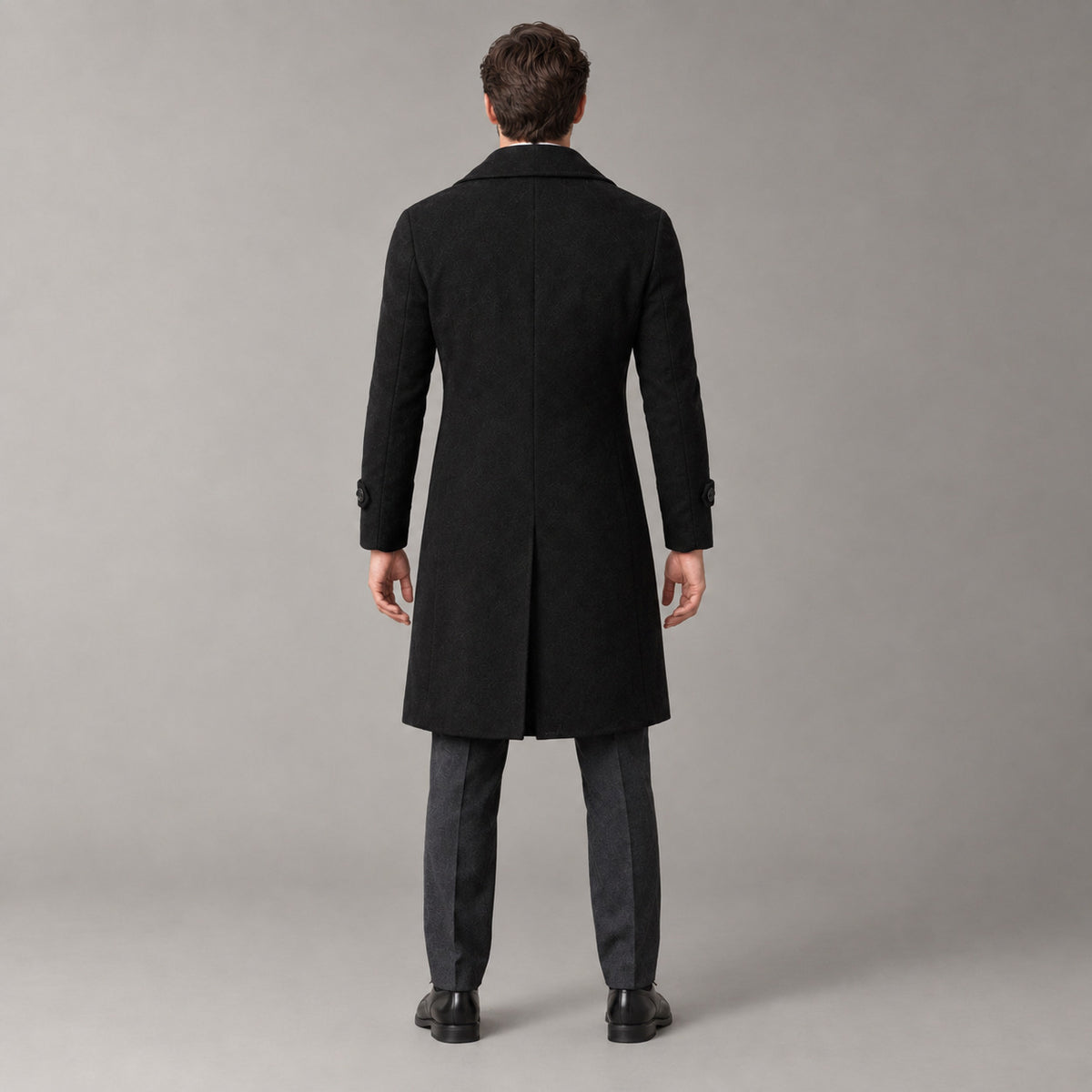 Norbury Cotton Blend Trench Coat — Back of the black double-breasted trench coat worn, showing the centre back vent.