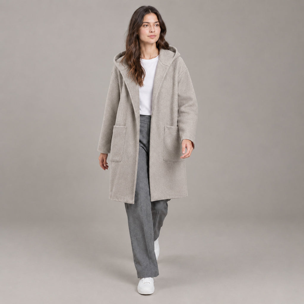 Lothian Brushed Hooded Coat — Solid heather oatmeal relaxed mid-length hooded coat worn by a model against a neutral studio backdrop.