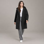 Lothian Brushed Hooded Coat — Solid black relaxed mid-length hooded coat worn by a model against a neutral studio backdrop.