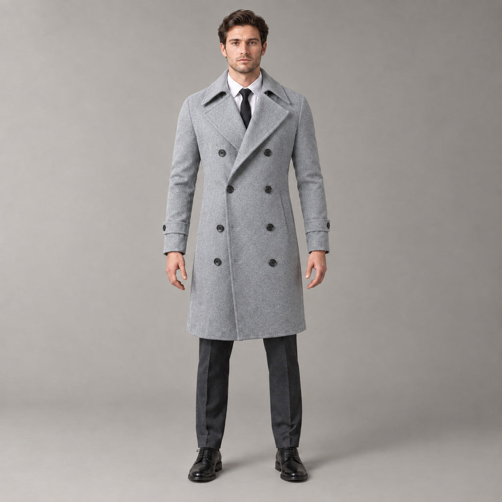Norbury Cotton Blend Trench Coat — Light gray double-breasted trench coat worn by a model against a pale stone studio backdrop.