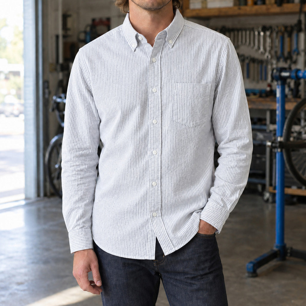 Longford Cotton Oxford Shirt — Gray Stripe cotton oxford shirt worn by a model in a navy panelled room.
