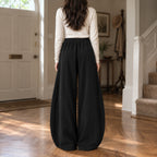 Ormsby Ribbed Wide Leg Trousers — Back of the black ribbed wide-leg pants worn, showing the centre back seam.
