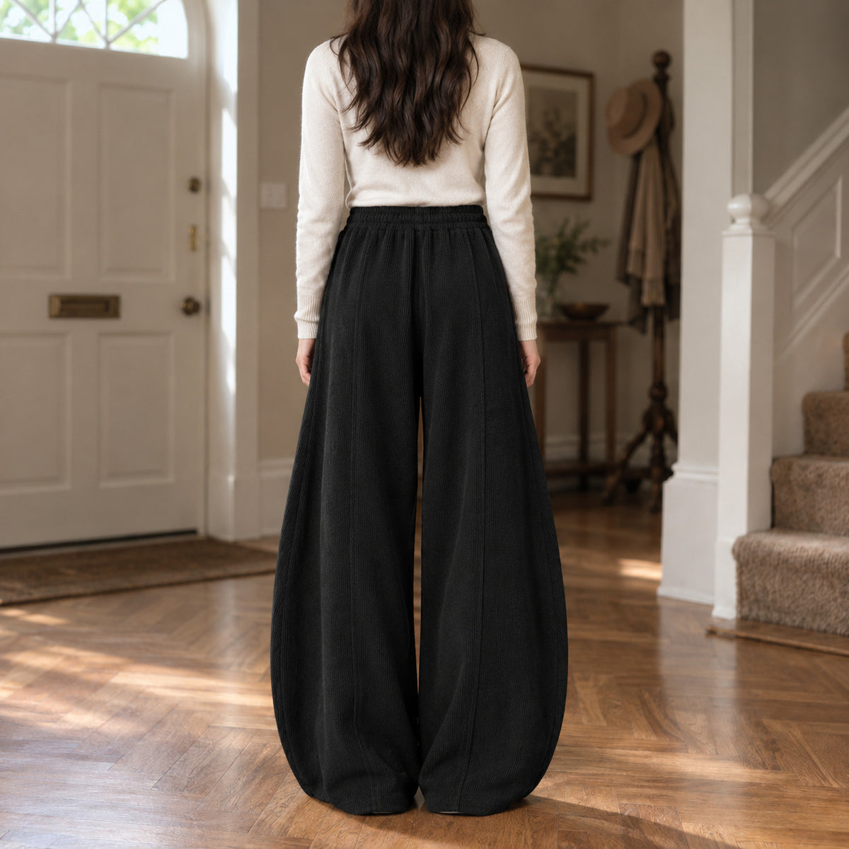 Ormsby Ribbed Wide Leg Trousers — Back of the black ribbed wide-leg pants worn, showing the centre back seam.