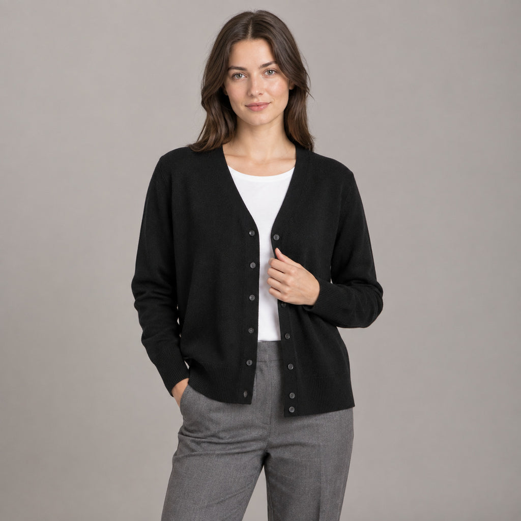 Merrion Fine Knit Cardigan — Black V-neck button-down cardigan worn by a model against a seamless studio wall.
