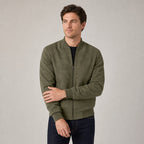 Hartfield Faux Suede Bomber Jacket — Army green faux-suede bomber jacket worn by a model against a pale stone studio backdrop