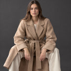 Tamworth Belted Wrap Coat — Camel belted wrap coat worn by a model in a studio setting.