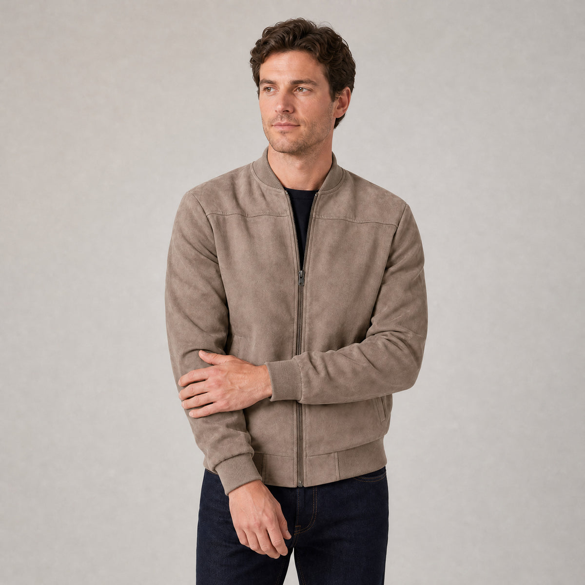 Hartfield Faux Suede Bomber Jacket — Khaki faux-suede bomber jacket worn by a model against a pale stone studio backdrop