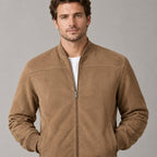 Kinloch Faux Suede Bomber Jacket — Caramel faux-suede bomber jacket worn, cropped from shoulders to waist showing stand collar and zip placket.