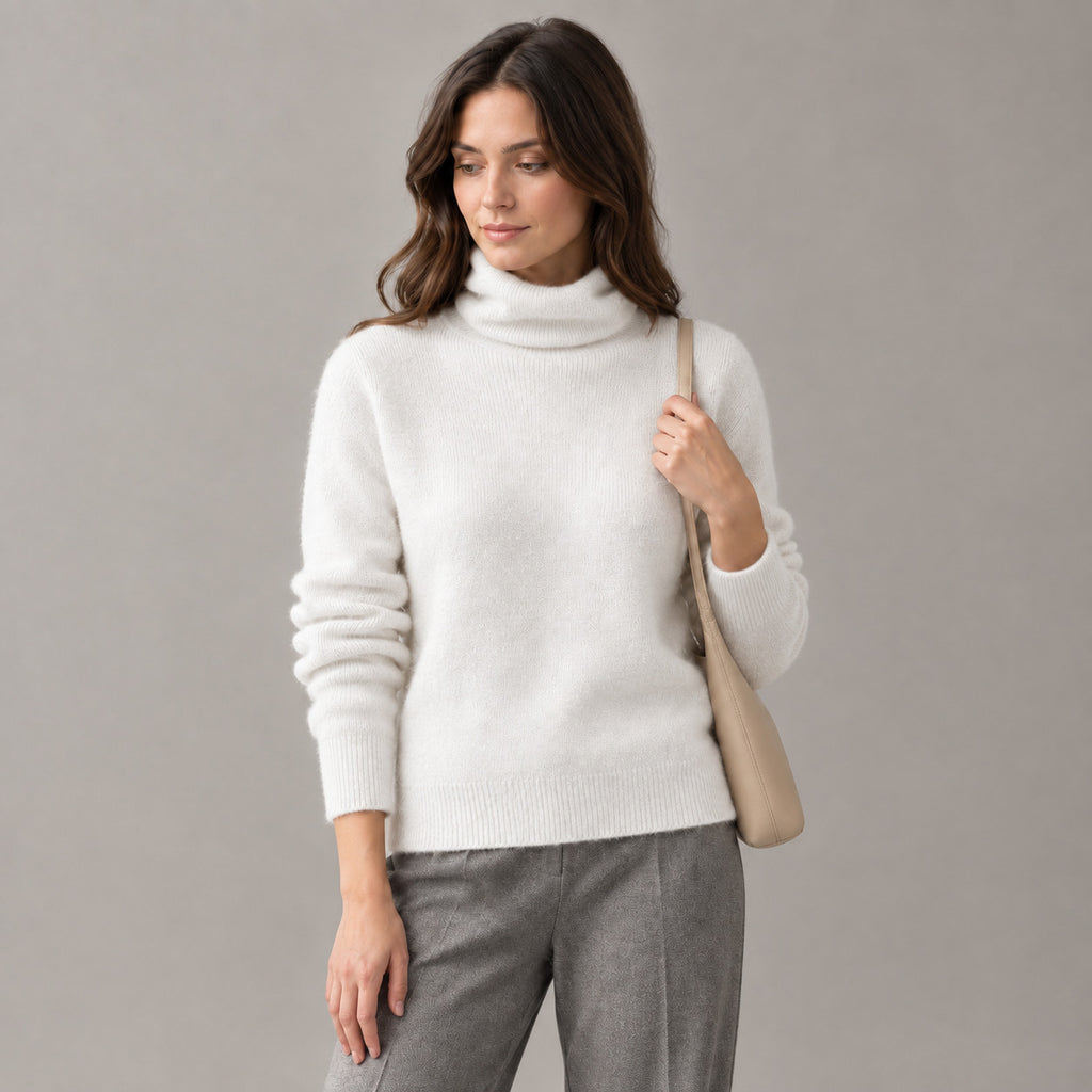 Rothbury Ribbed Knit Turtleneck — White turtleneck sweater worn by a model against a neutral studio backdrop.
