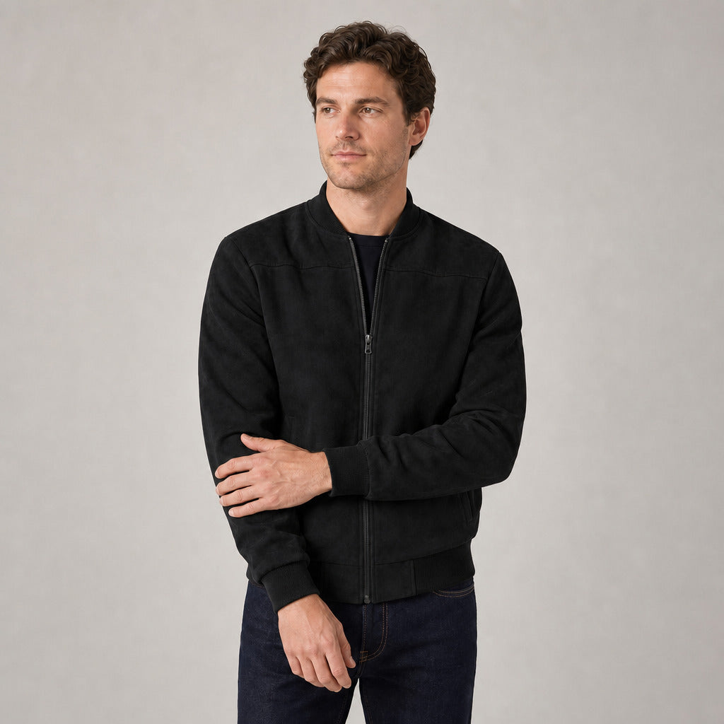 Hartfield Faux Suede Bomber Jacket — Black faux-suede bomber jacket worn by a model against a pale stone studio backdrop
