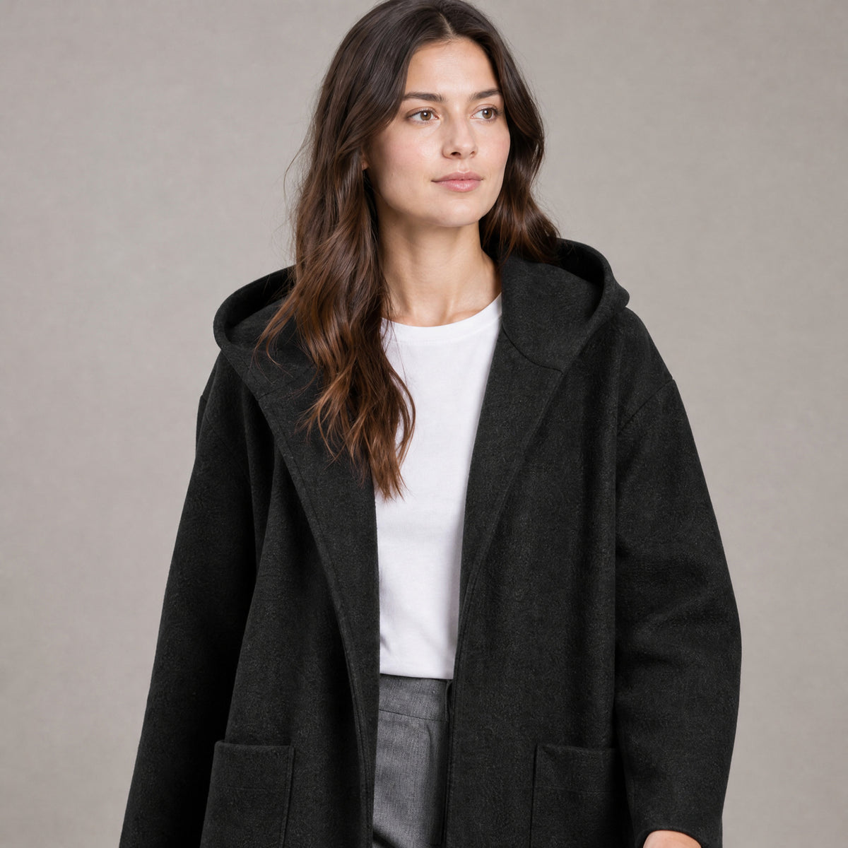 Lothian Brushed Hooded Coat — Solid black relaxed mid-length hooded coat worn, cropped from the shoulders to the waist to show the neckline and closure.