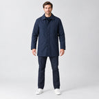 Chalcot Quilted Car Coat — Navy blue car coat worn by a model against a studio backdrop.