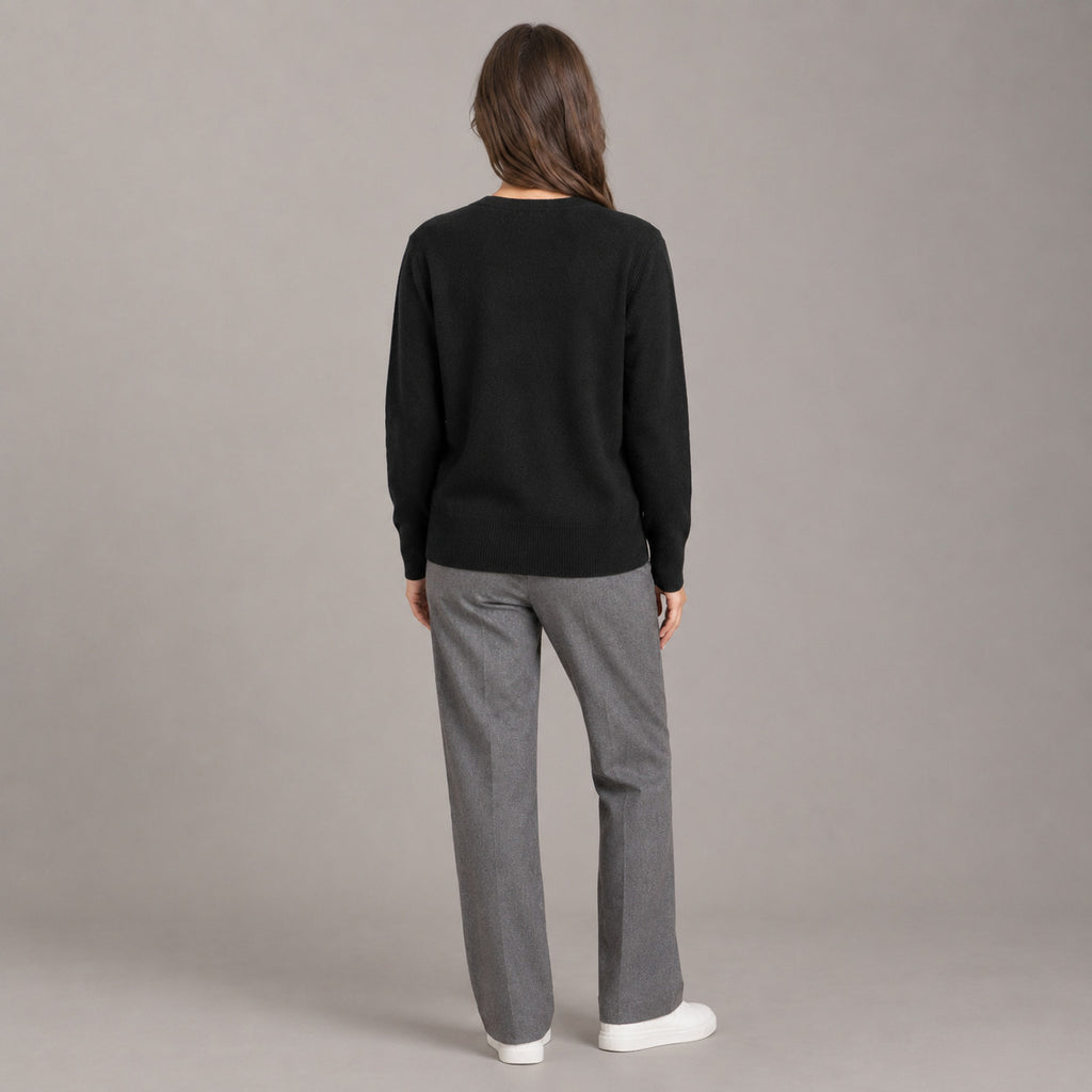 Merrion Fine Knit Cardigan — Back of the black V-neck button-down cardigan worn, showing the smooth knit back and ribbed hem.