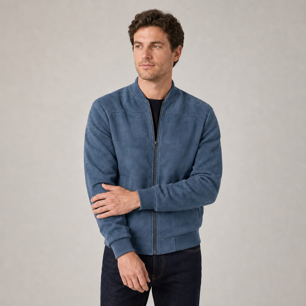 Hartfield Faux Suede Bomber Jacket — Peacock blue faux-suede bomber jacket worn by a model against a pale stone studio backdrop
