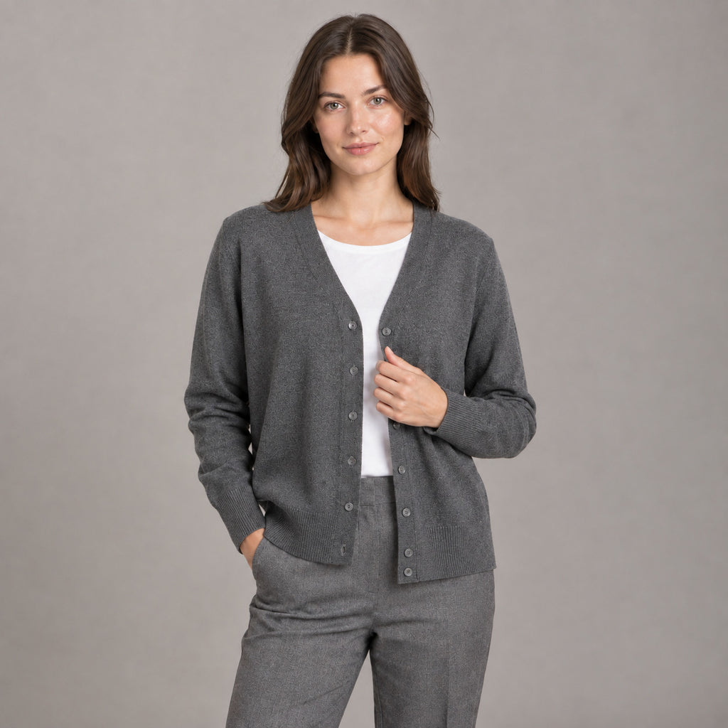 Merrion Fine Knit Cardigan — Dark gray V-neck button-down cardigan worn by a model against a seamless studio wall.