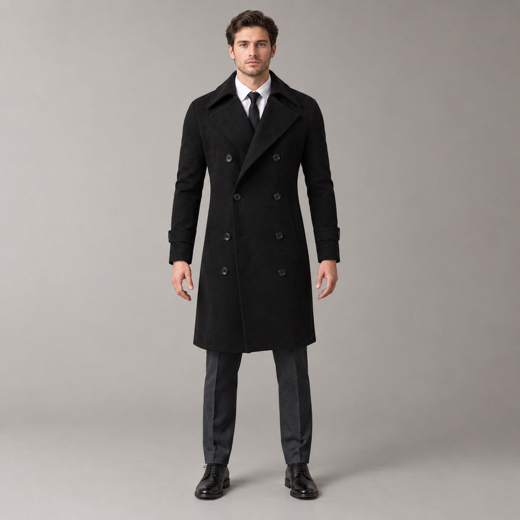 Norbury Cotton Blend Trench Coat — Black double-breasted trench coat worn by a model against a pale stone studio backdrop.