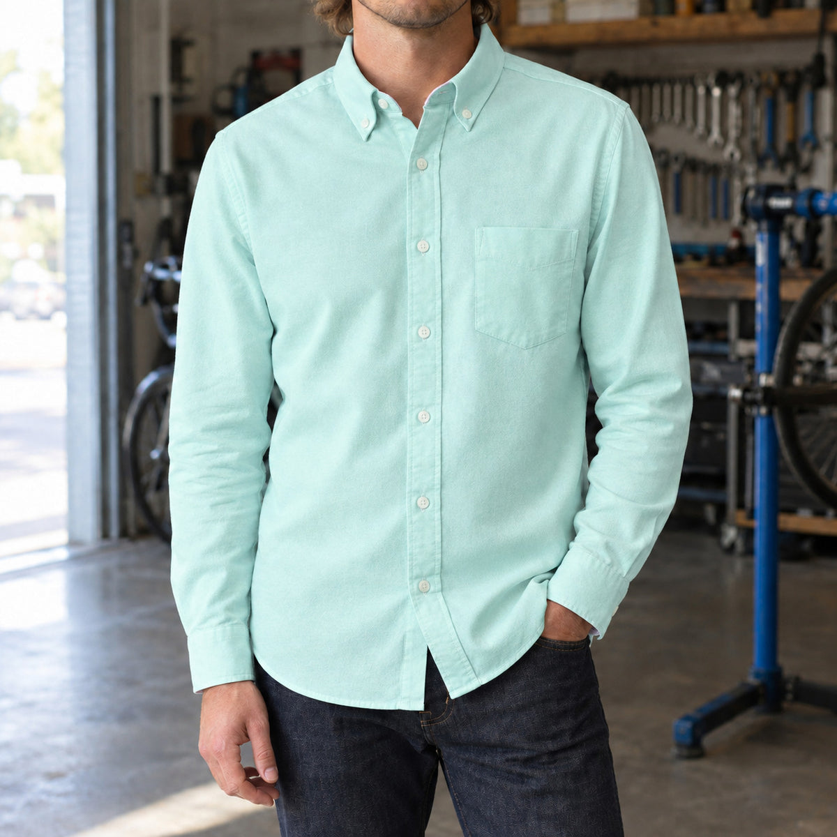 Longford Cotton Oxford Shirt — Green cotton oxford shirt worn by a model in a navy panelled room.