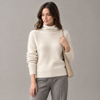 Rothbury Ribbed Knit Turtleneck — Beige turtleneck sweater worn by a model against a neutral studio backdrop.