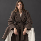 Tamworth Belted Wrap Coat — Brown belted wrap coat worn by a model in a studio setting.
